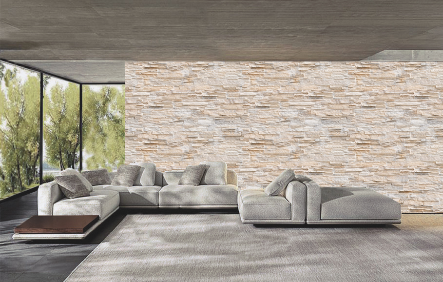 Graues modulares Loungesofa mit Chaiselongue und Couchtisch in modernem Wohnzimmer vor heller Natursteinwand und großen Fenstern